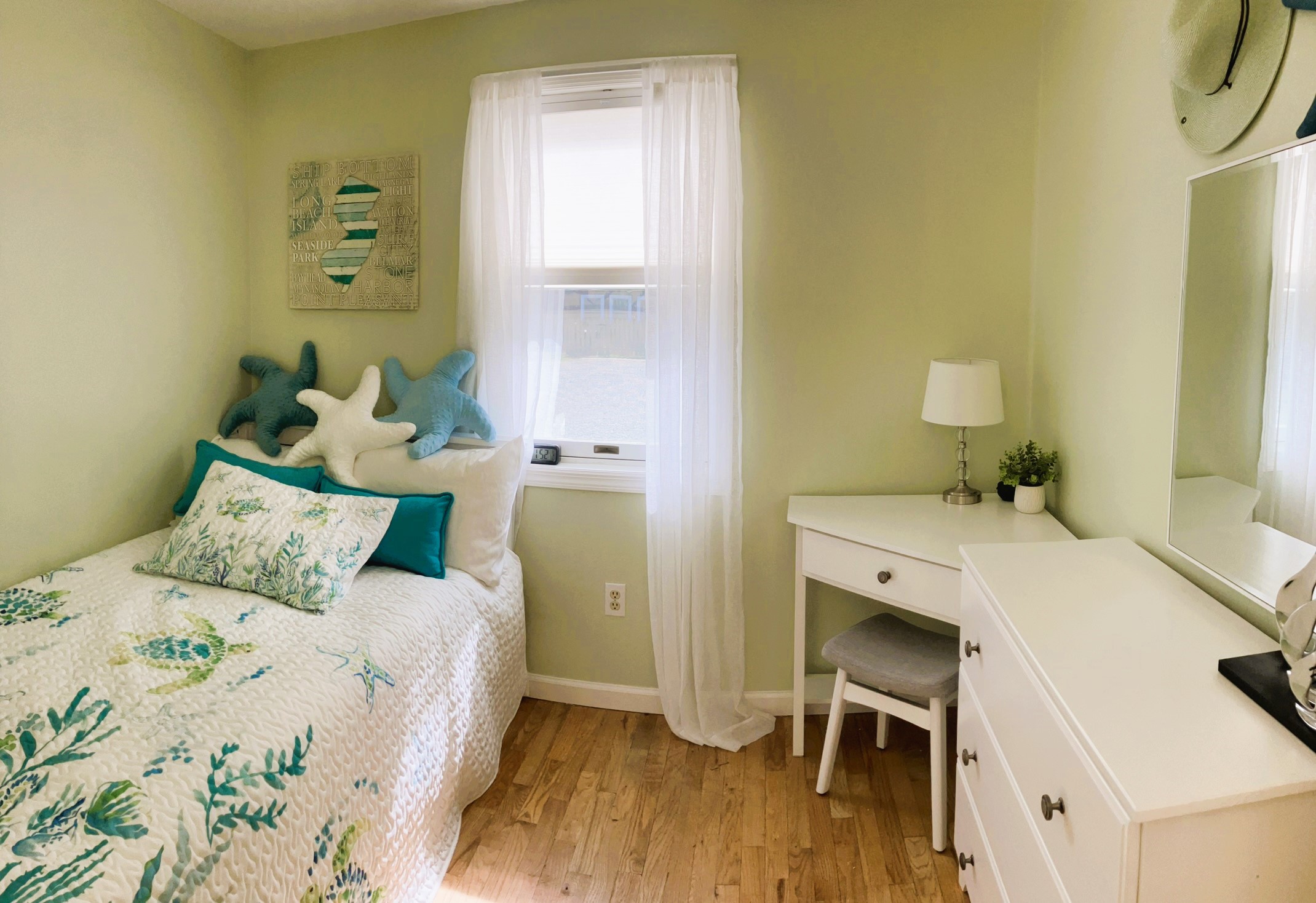 Kids bedroom with small dresser and desk