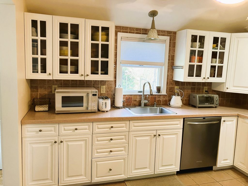 white kitchen fully equipped to make meals at home