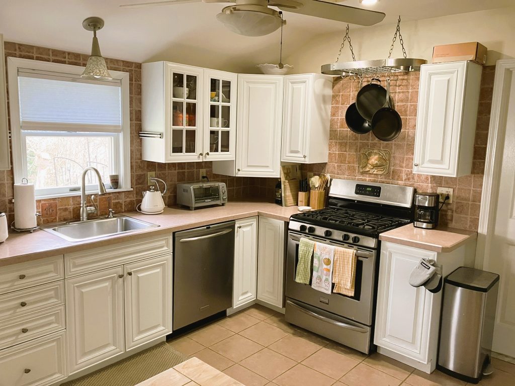 Eat-in kitchen with stove, microwave oven, toaster and many other small appliances to enjoy meals at home.