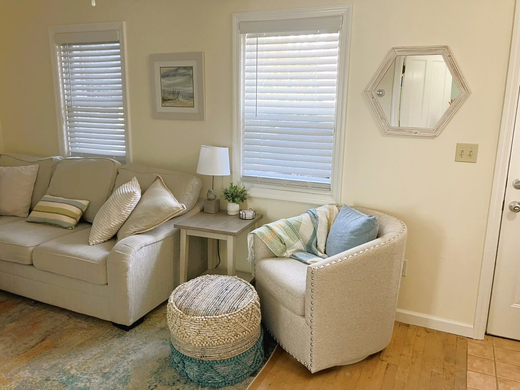 Swivel chair and sectional couch provide seating in the living room.