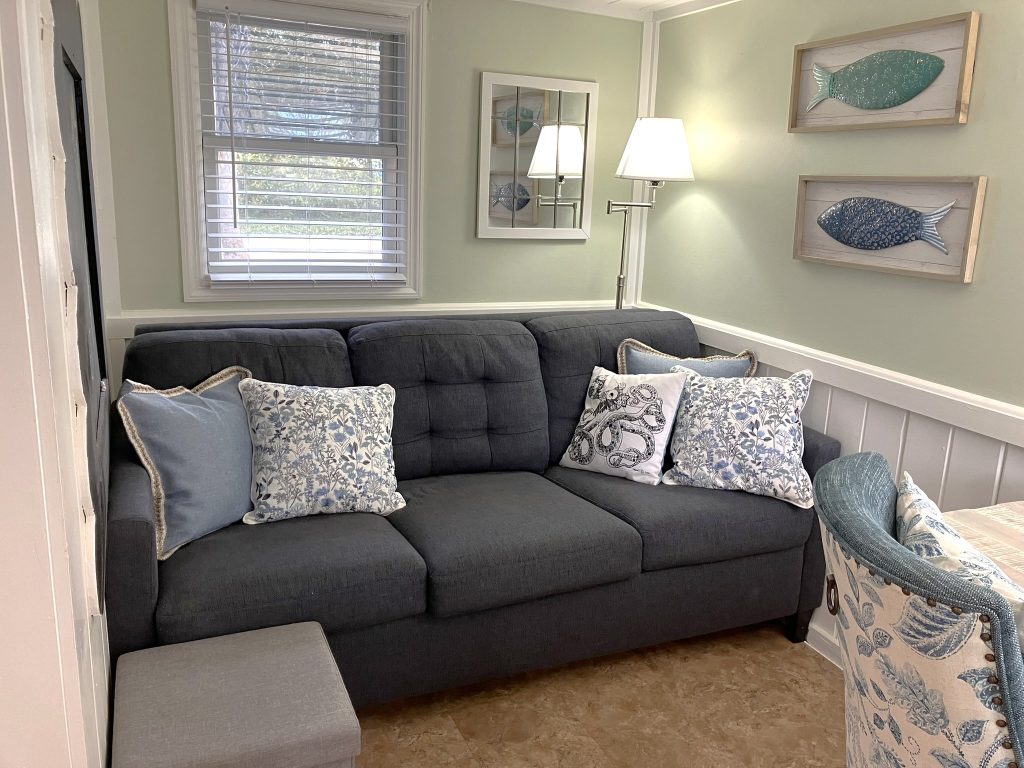 A small sitting area is located just off the kitchen with reading light